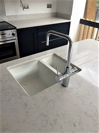 Hahue blue and wevel Classical Kitchen with chrome tap and ceramic sink.
